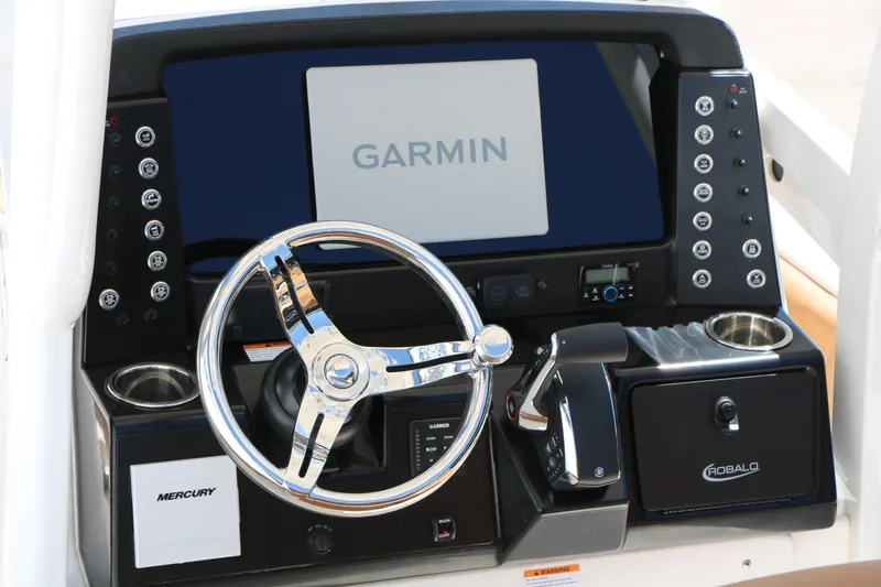 Slide: The Image of 2026 Robalo 246 Cayman boat dashboard with Garmin display and Mercury controls. - 17