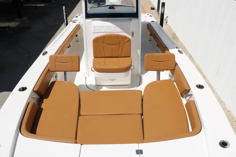 Slide: The Image of 2026 Robalo 246 Cayman boat interior with tan seating and spacious layout. - 24