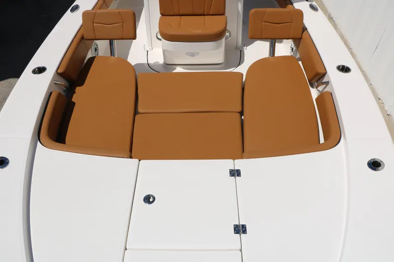 Slide: The Image of 2026 Robalo 246 Cayman boat with tan cushioned seating and white deck. - 25