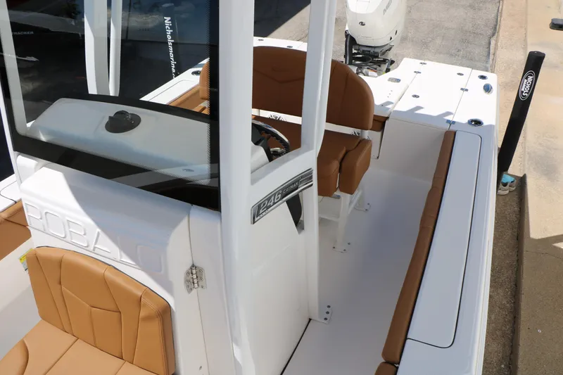 Slide: The Image of 2026 Robalo 246 Cayman boat interior with tan seating and console. - 27