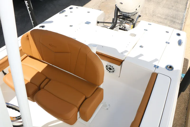 Slide: The Image of 2026 Robalo 246 Cayman boat interior with tan seating and white deck. - 28