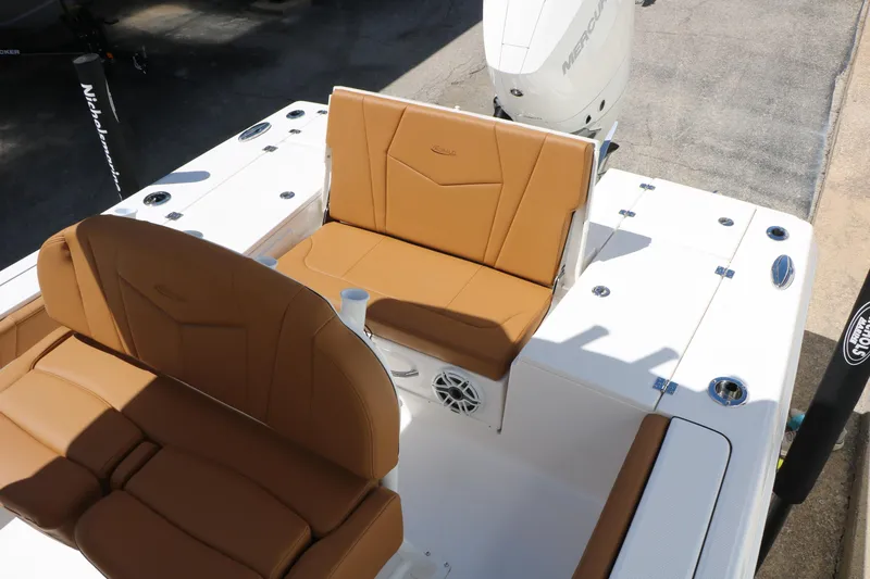 Slide: The Image of 2026 Robalo 246 Cayman boat interior with tan seating and white deck. - 29