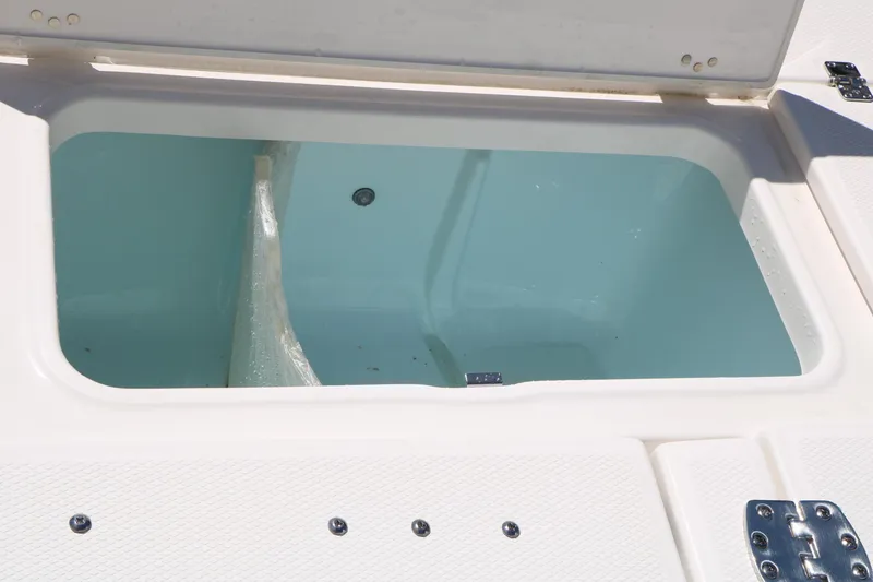 Slide: The Image of Livewell compartment on 2026 Robalo 246 Cayman boat, open lid view. - 37