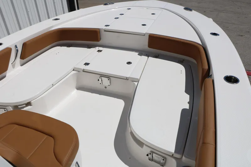 Slide: The Image of 2026 Robalo 246 Cayman boat interior with white deck and tan seating. - 39
