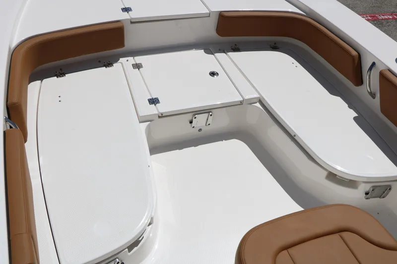 Slide: The Image of 2026 Robalo 246 Cayman boat interior with white deck and brown seating. - 42
