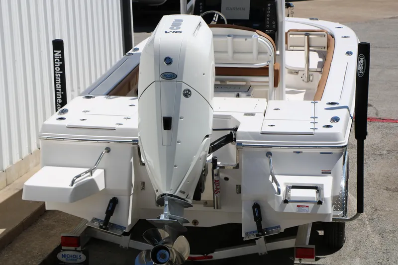 Slide: The Image of 2026 Robalo 246 Cayman boat with powerful outboard motor, docked at marina. - 44