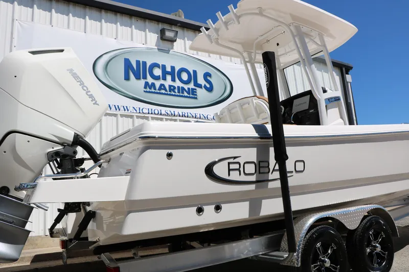 Slide: The Image of 2026 Robalo 246 Cayman boat at Nichols Marine dealership. - 5