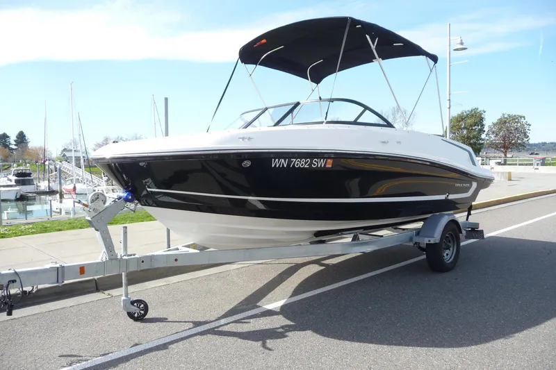 Slide: The Image of 2021 Bayliner VR5 Bowrider I/O on trailer at marina, sunny day. - 13
