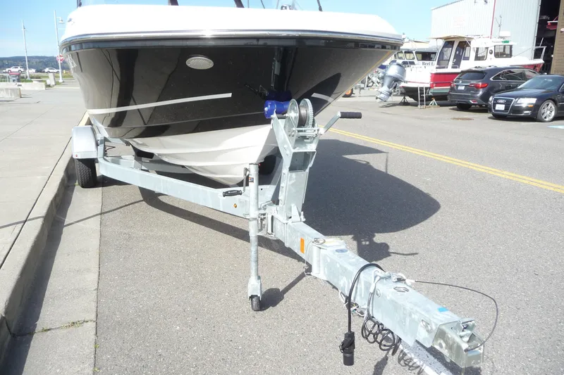 Slide: The Image of 2021 Bayliner VR5 Bowrider I/O on trailer, parked on a sunny street. - 14