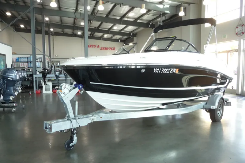 Slide: The Image of 2021 Bayliner VR5 Bowrider I/O on trailer in showroom setting. - 17