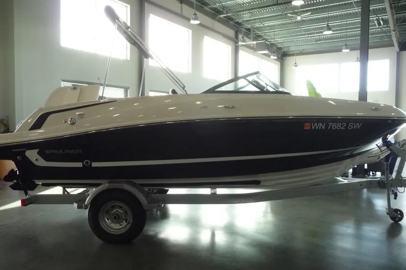 Slide: The Image of 2021 Bayliner VR5 Bowrider I/O boat on trailer in indoor showroom. - 18