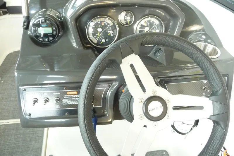 Slide: The Image of 2021 Bayliner VR5 Bowrider I/O dashboard with steering wheel and gauges. - 21