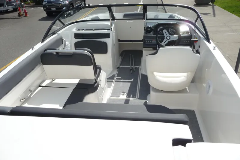 Slide: The Image of 2021 Bayliner VR5 Bowrider I/O interior with seating and steering wheel. - 5