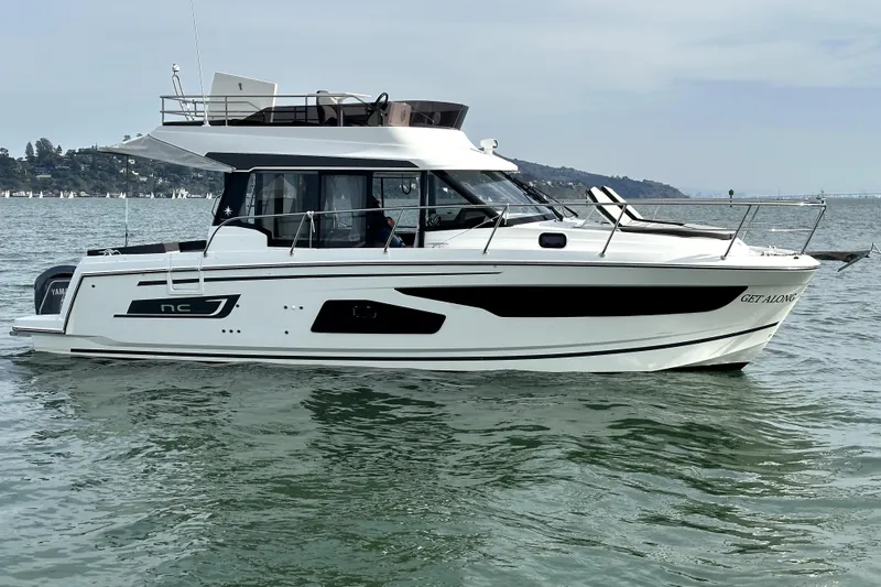 The Image of 2022 Jeanneau NC Weekender 1095 Fly boat on calm water, side view. - 0