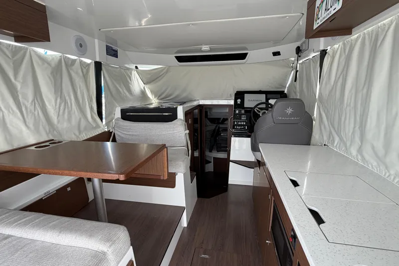 Slide: The Image of Interior of 2022 Jeanneau NC Weekender 1095 Fly, featuring helm, seating, and dining area. - 11