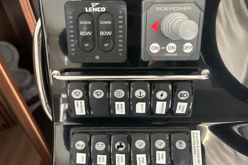 Slide: The Image of Control panel of 2022 Jeanneau NC Weekender 1095 Fly with labeled switches and thruster controls. - 13