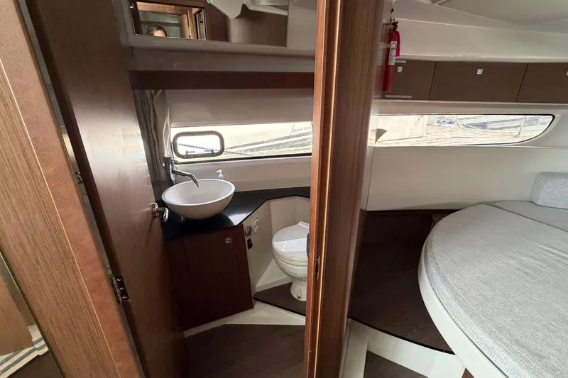 Slide: The Image of Interior of 2022 Jeanneau NC Weekender 1095 Fly, featuring bathroom and sleeping area. - 19