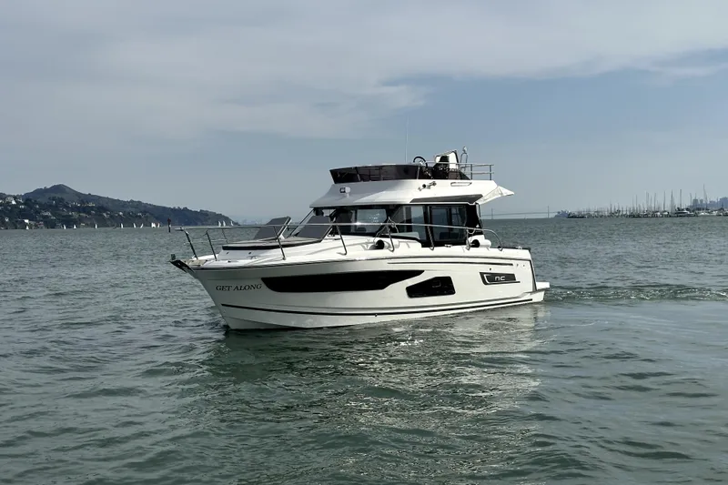 Slide: The Image of 2022 Jeanneau NC Weekender 1095 Fly cruising on calm waters. - 2