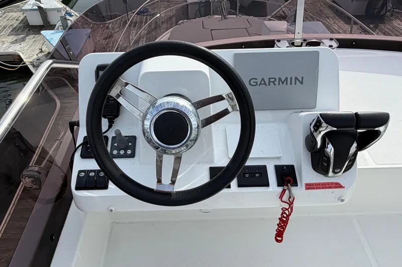 Slide: The Image of Steering console of 2022 Jeanneau NC Weekender 1095 Fly with Garmin navigation. - 23