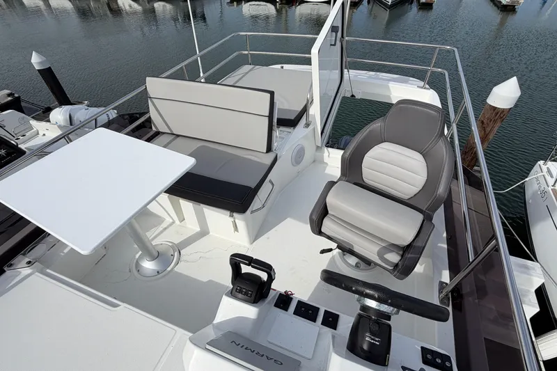 Slide: The Image of Flybridge of 2022 Jeanneau NC Weekender 1095 Fly with seating and helm station. - 24