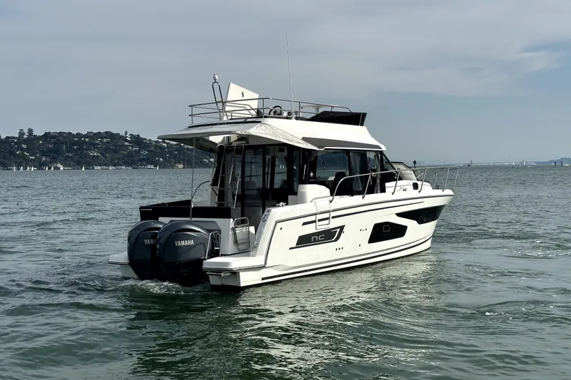Slide: The Image of 2022 Jeanneau NC Weekender 1095 Fly cruising on open water with twin Yamaha engines. - 7