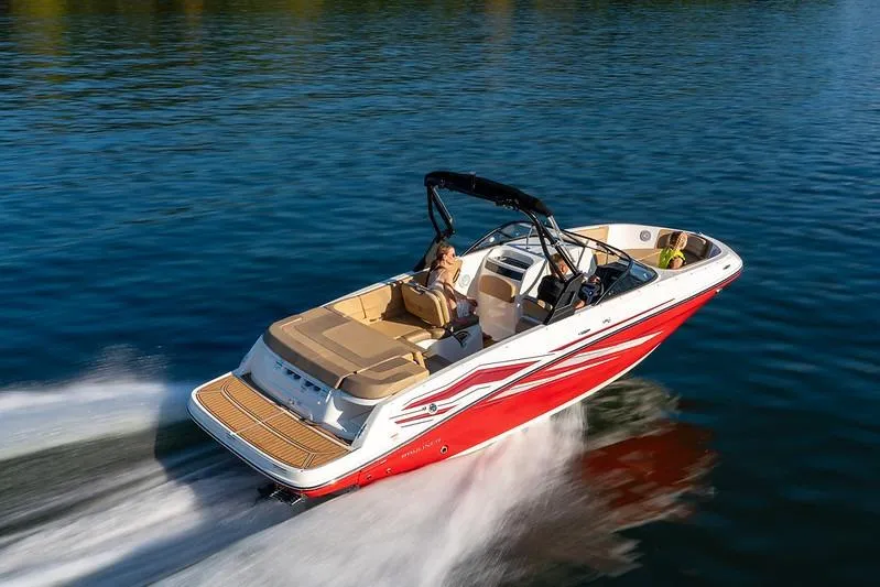 The Image of 2026 Bayliner VR6 Bowrider I/O cruising on a serene lake. - 1