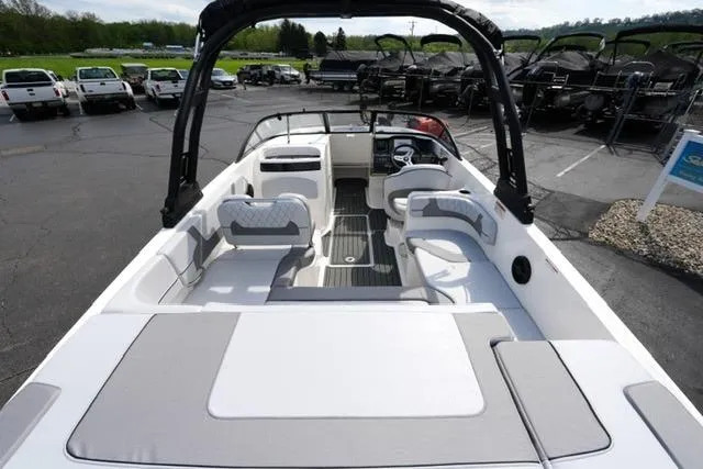 Slide: The Image of 2026 Bayliner VR6 Bowrider I/O boat interior with seating and dashboard, parked outdoors. - 10