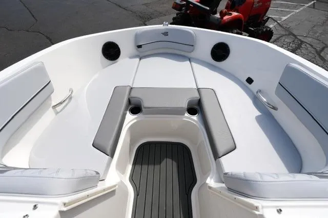 Slide: The Image of 2026 Bayliner VR6 Bowrider I/O boat interior with cushioned seating and cup holders. - 12