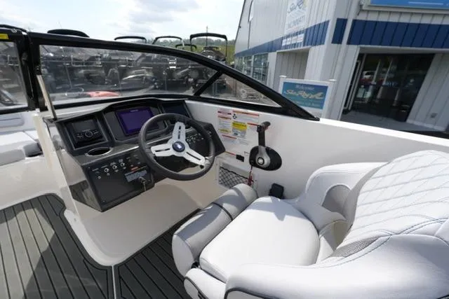 Slide: The Image of 2026 Bayliner VR6 Bowrider I/O cockpit with modern steering and controls, featuring sleek design. - 17