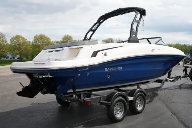 Slide: The Image of 2026 Bayliner VR6 Bowrider I/O boat on trailer, blue and white design, parked outdoors. - 6