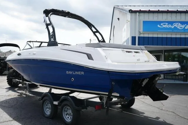 Slide: The Image of 2026 Bayliner VR6 Bowrider I/O boat on trailer, parked outside dealership. - 8