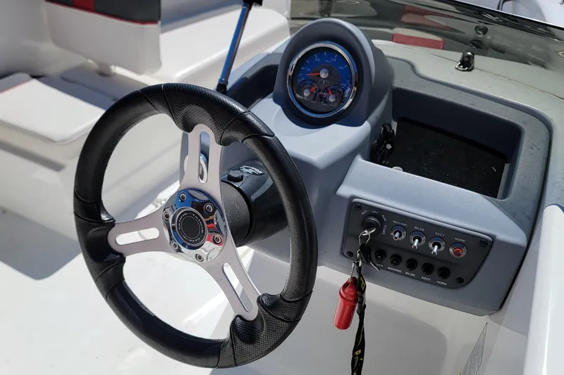 Slide: The Image of Steering wheel and dashboard of a 2021 Tahoe T16 boat. - 8