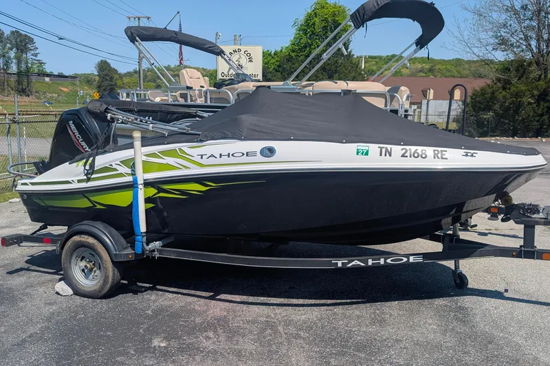 Slide: The Image of 2021 Tahoe T16 boat on trailer with cover, parked outdoors. - 1
