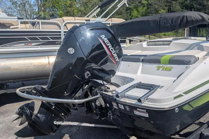 Slide: The Image of 2021 Tahoe T16 boat with Mercury outboard motor, docked near other boats. - 10