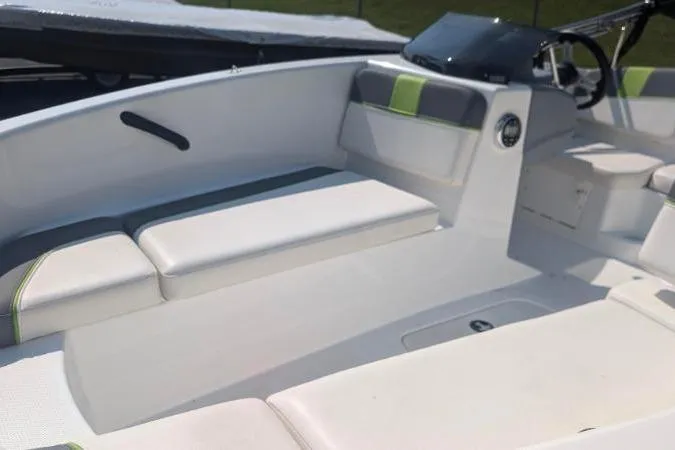 Slide: The Image of 2021 Tahoe T16 boat interior with white seating and green accents. - 6