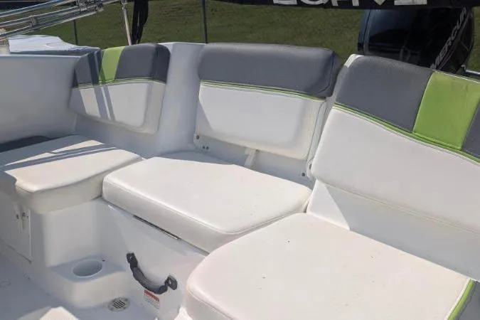 Slide: The Image of 2021 Tahoe T16 boat interior with white and gray seating, accented by green stripes. - 8