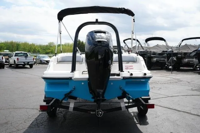 Slide: The Image of 2026 Bayliner M17 boat with outboard motor, parked in a marina lot. - 14