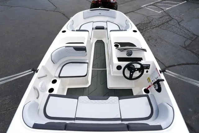 Slide: The Image of 2026 Bayliner M17 boat interior with modern seating and steering wheel. - 16