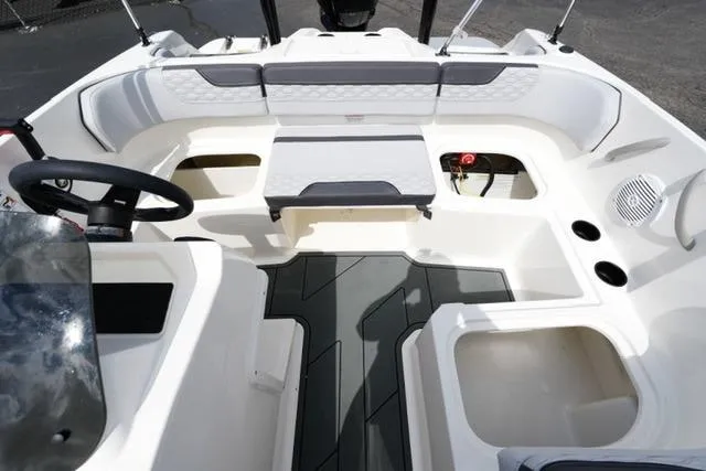 Slide: The Image of 2026 Bayliner M17 boat interior with seating, steering wheel, and storage compartments. - 21