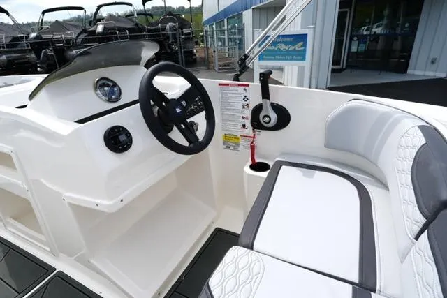 Slide: The Image of 2026 Bayliner M17 boat interior with steering wheel and seating area. - 22