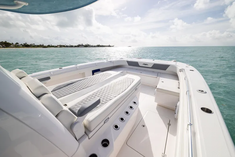 Slide: The Image of 2023 Invincible 37 Catamaran on serene ocean, showcasing luxurious seating and sleek design. - 11