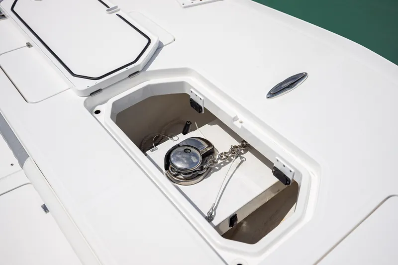 Slide: The Image of Anchor compartment of 2023 Invincible 37 Catamaran, showcasing storage and chain mechanism. - 14