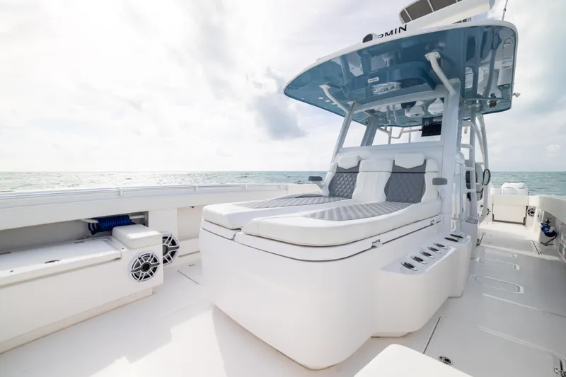 Slide: The Image of 2023 Invincible 37 Catamaran with luxurious seating and ocean backdrop. - 16