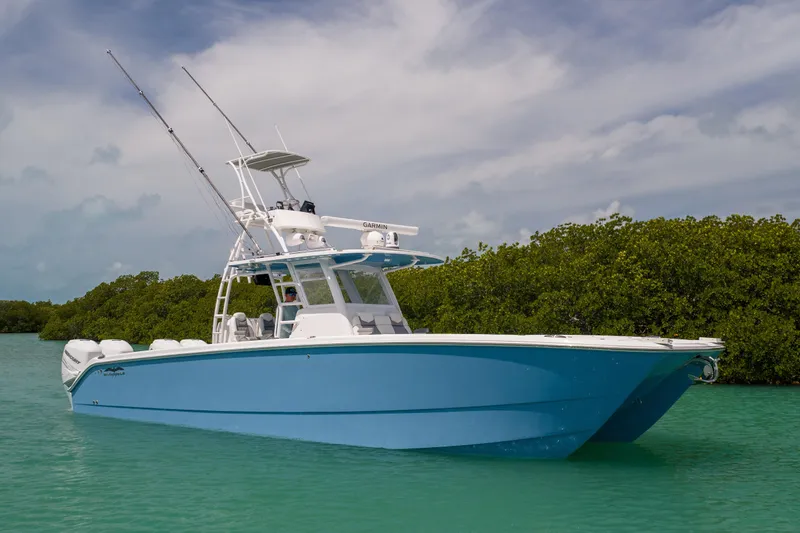 Slide: The Image of 2023 Invincible 37 Catamaran in turquoise waters, featuring sleek design and advanced technology. - 2