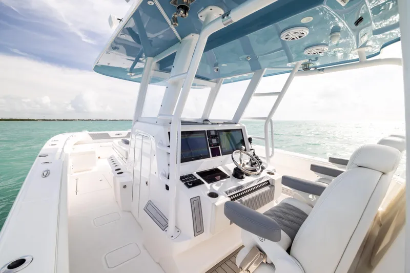 Slide: The Image of 2023 Invincible 37 Catamaran interior with modern helm, ocean view, and luxurious seating. - 21