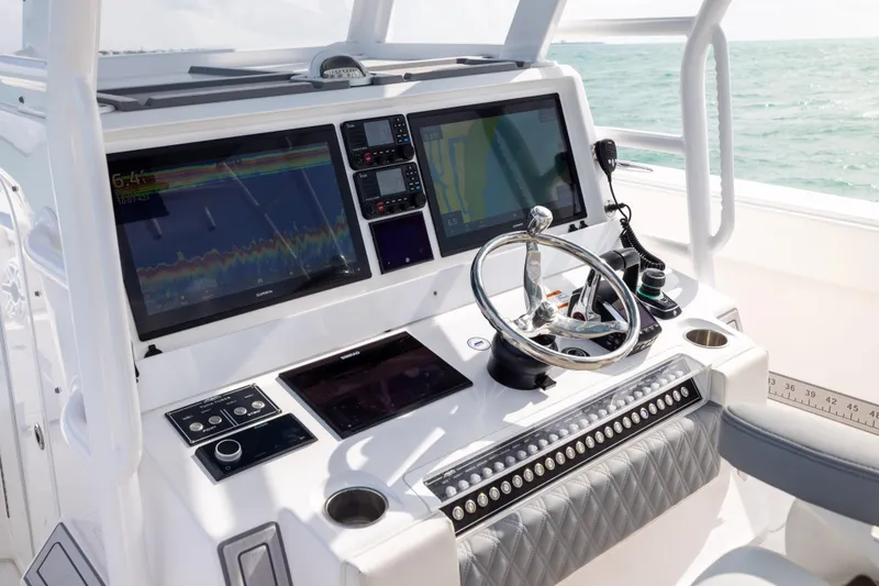 Slide: The Image of Helm of 2023 Invincible 37 Catamaran with advanced navigation displays and controls. - 22
