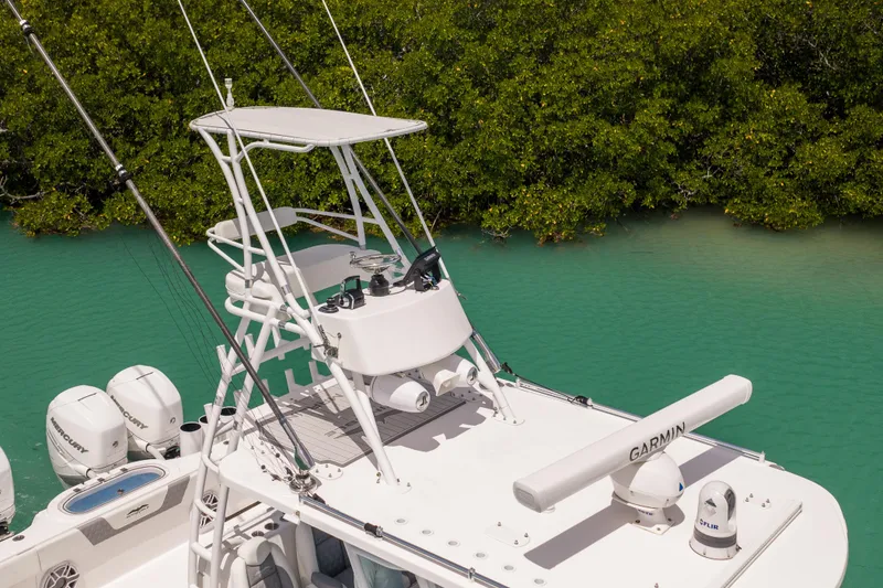 Slide: The Image of 2023 Invincible 37 Catamaran with advanced navigation equipment on turquoise water. - 23