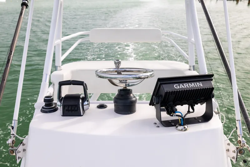 Slide: The Image of Helm of 2023 Invincible 37 Catamaran with Garmin navigation system on calm waters. - 26