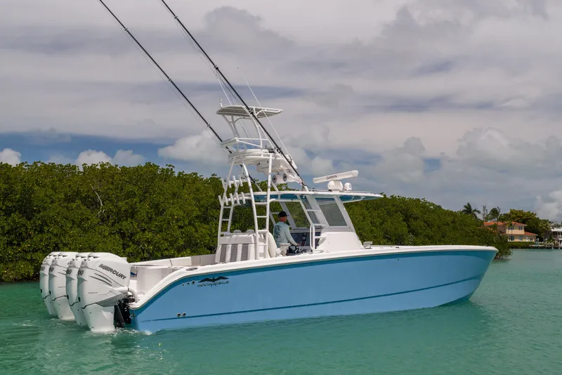 Slide: The Image of 2023 Invincible 37 Catamaran in turquoise waters, featuring multiple outboard engines. - 3