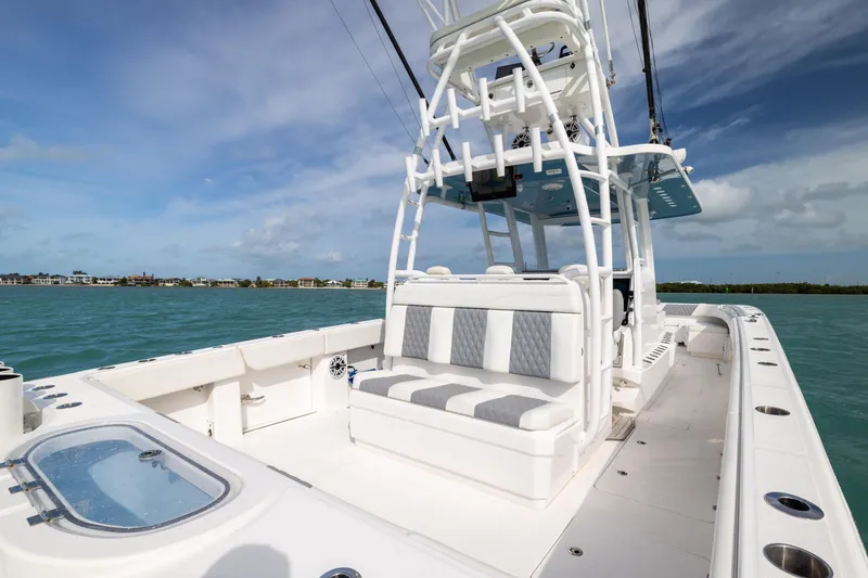 Slide: The Image of 2023 Invincible 37 Catamaran on water, featuring spacious seating and sleek design. - 30